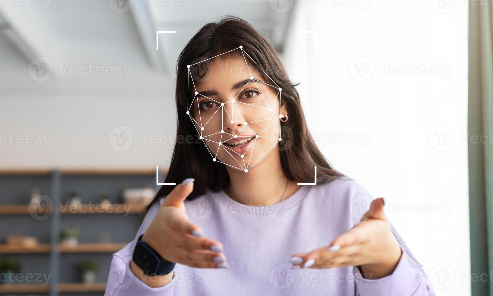 A person explains a concept while facial recognition technology analyzes their features. The setting is modern and well-lit, focusing on the relationship between technology and human interaction. photo