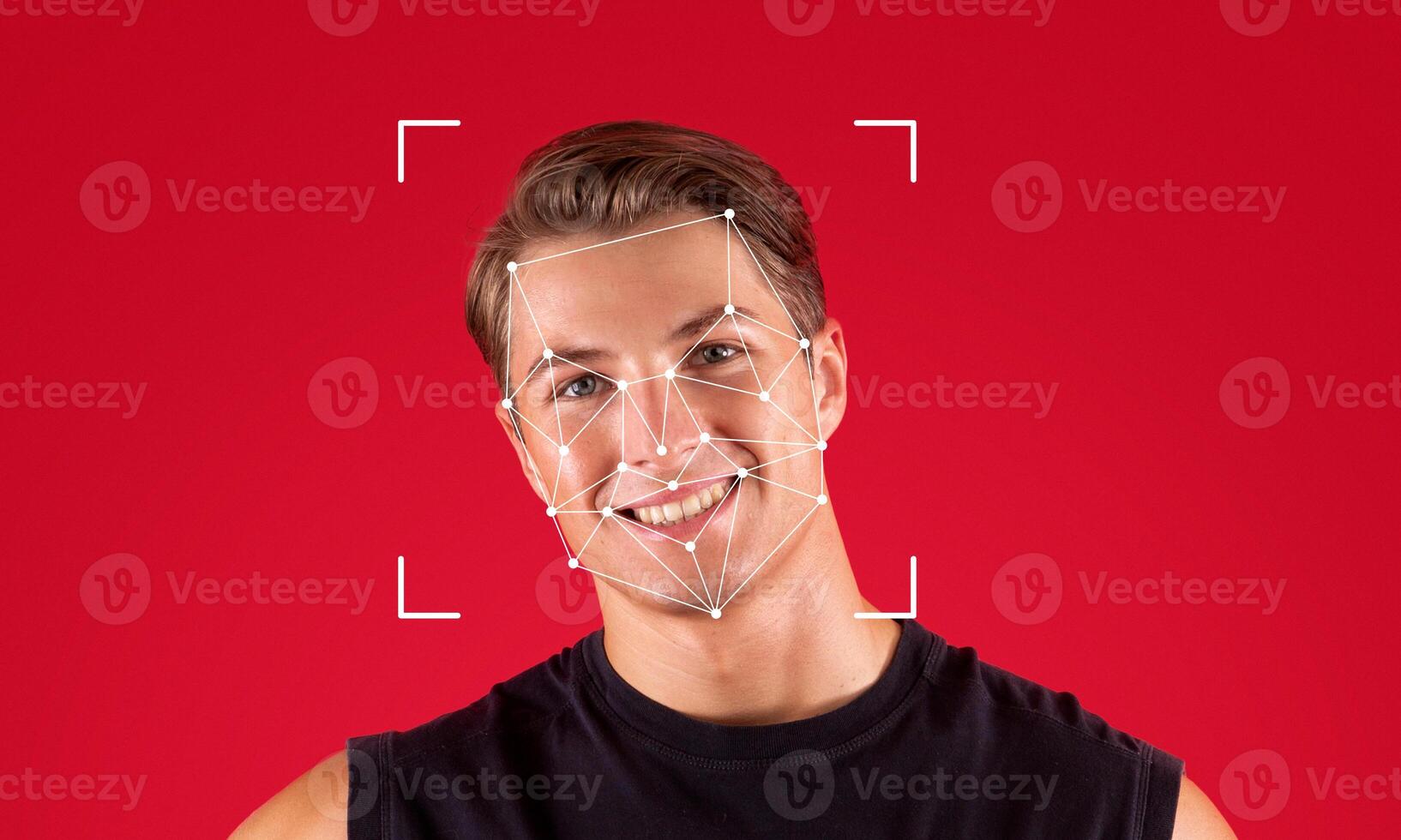 Facial recognition technology highlights a young man smiling against a vibrant red background. The geometric overlays represent identification features for tech applications in security. photo
