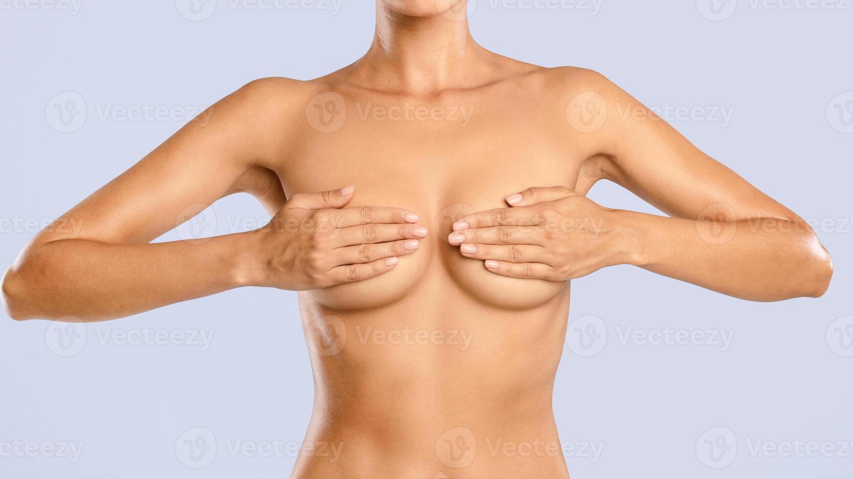 Body Care. Closeup Of Fit Topless Lady Covering Breast With Hands. Beauty And Healthcare Concept. Cropped View Of Slim Female Body With Smooth Healthy Skin On Blue Wall, Banner, Panorama photo