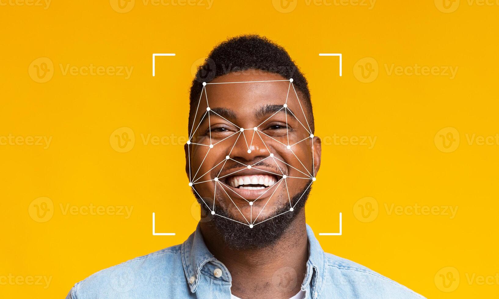 A man is smiling brightly against a vibrant yellow background, showcasing the application of facial recognition technology. Geometric patterns overlay his face to indicate detection. photo
