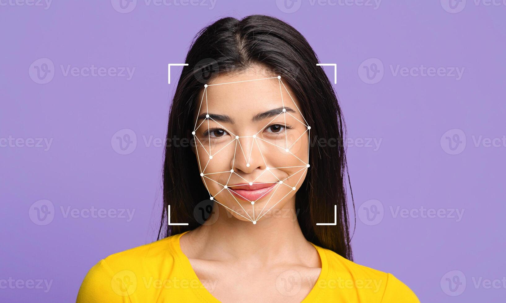 A woman smiles confidently as facial recognition technology overlays her features. The background is a solid purple, creating a striking contrast. photo