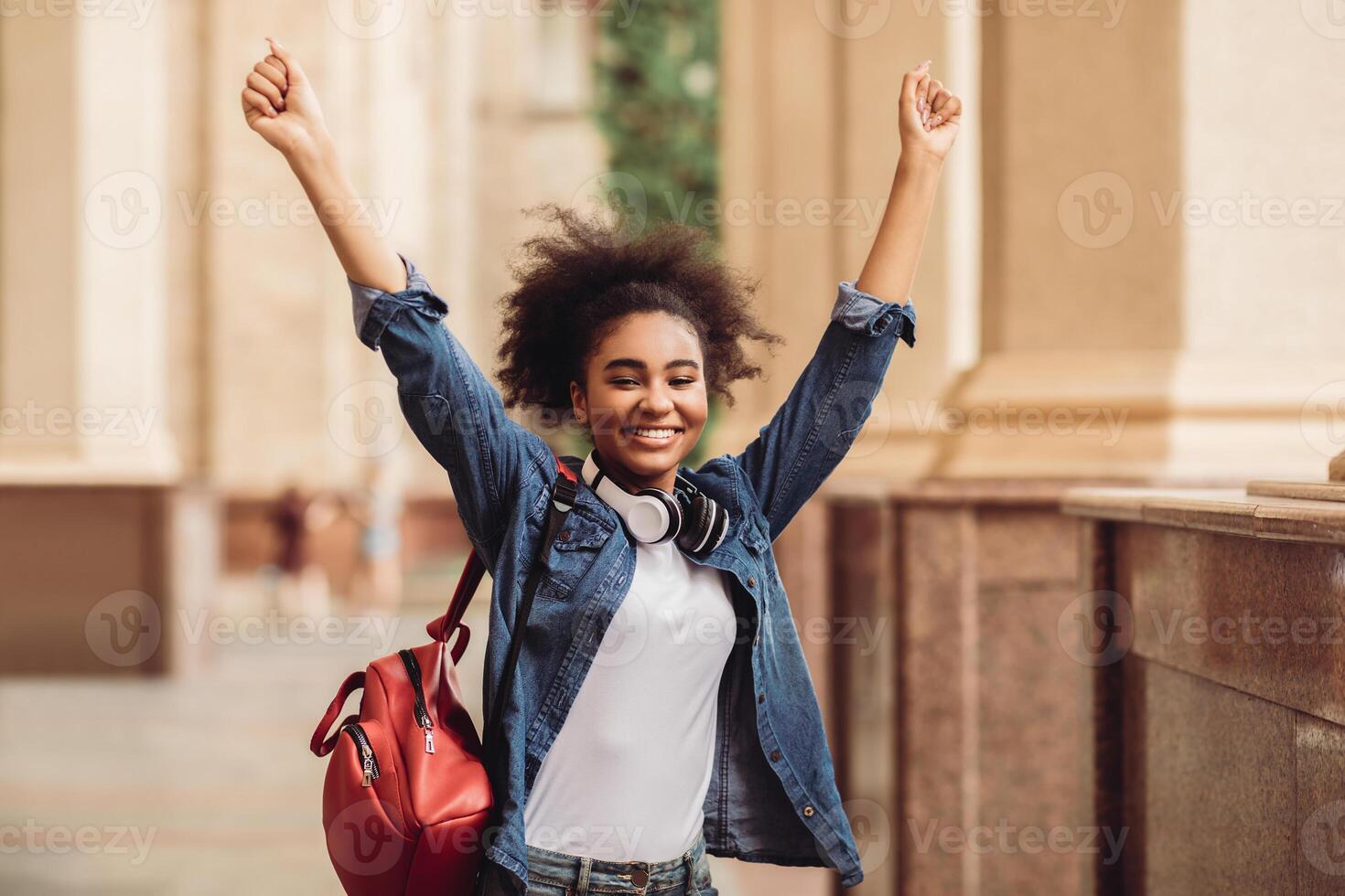 Passed Exam. Happy African American Student Girl Shaking Fists Celebrating Academic Success Standing At College Building Outside, Smiling To Camera. Education, Grants And Tuition. I Did It Concept photo