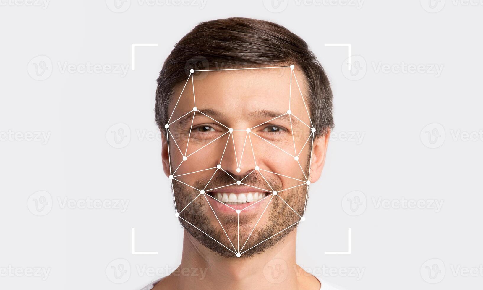 A smiling man is being analyzed by facial recognition technology. Geometric lines connect points on his face, indicating identification procedure. photo