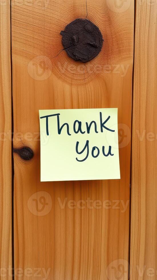 Note expressing gratitude attached to a wooden surface in a warm home environment photo