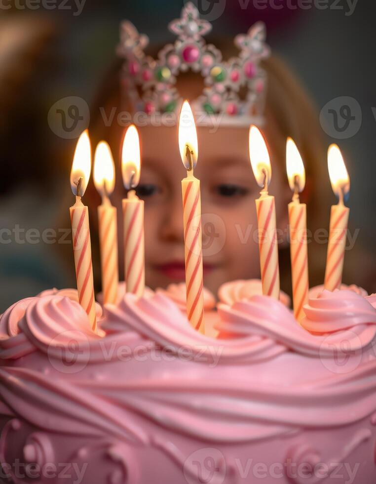 Celebration of a birthday with a pink cake and lit candles surrounded by cheerful atmosphere photo