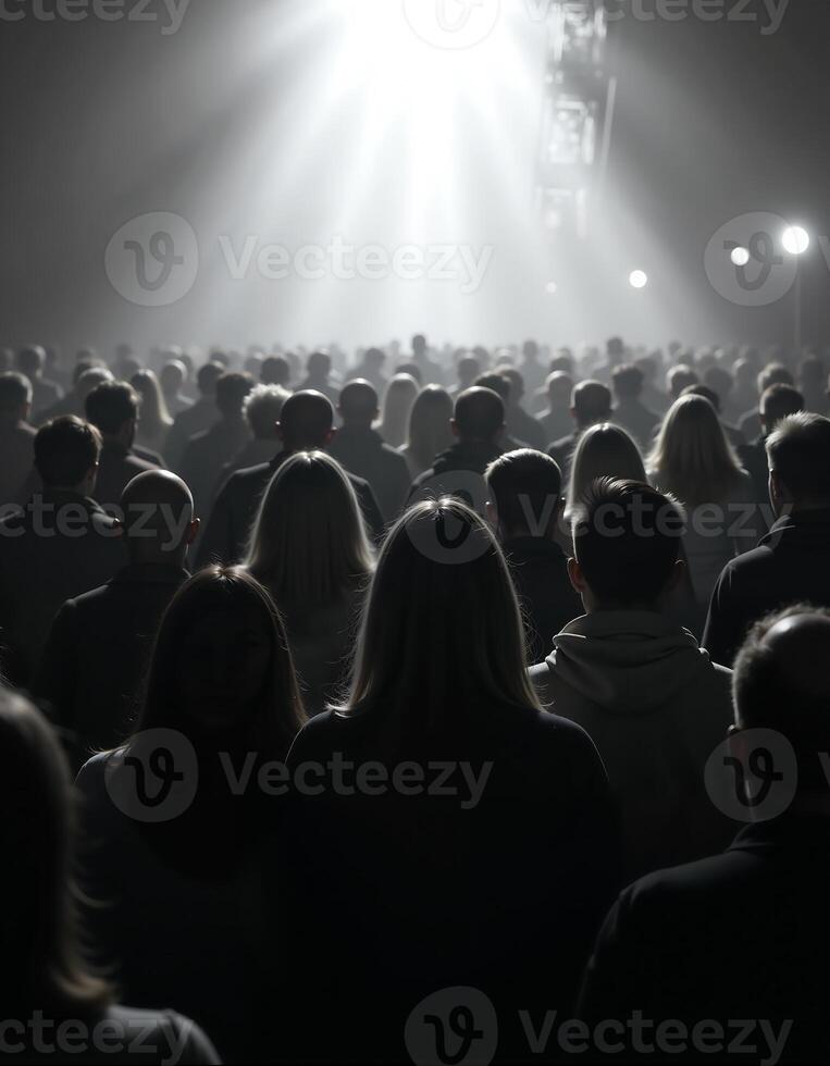 Crowd in silhouette under dramatic lighting at event photo