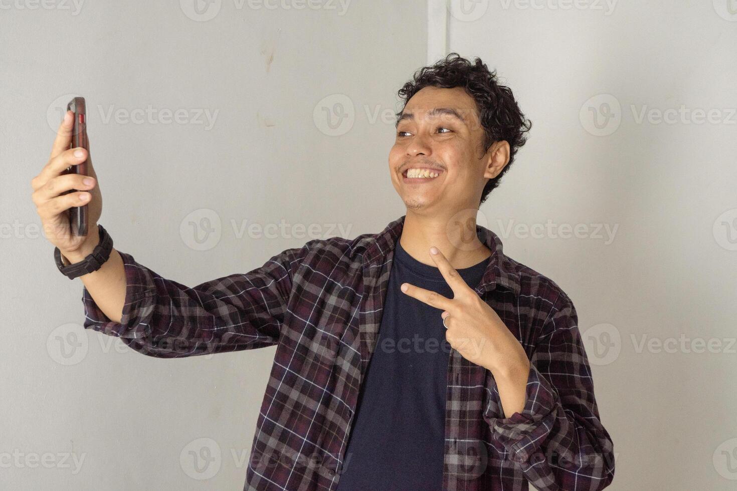 Happy Man Taking a Selfie with Peace Sign photo