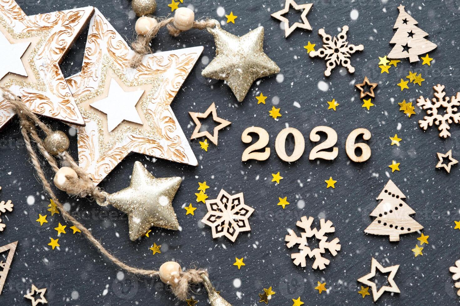Happy New Year-wooden letters and numbers 2026 festive black background with sequins, stars, snow. Greetings, postcard. Calendar, cover photo