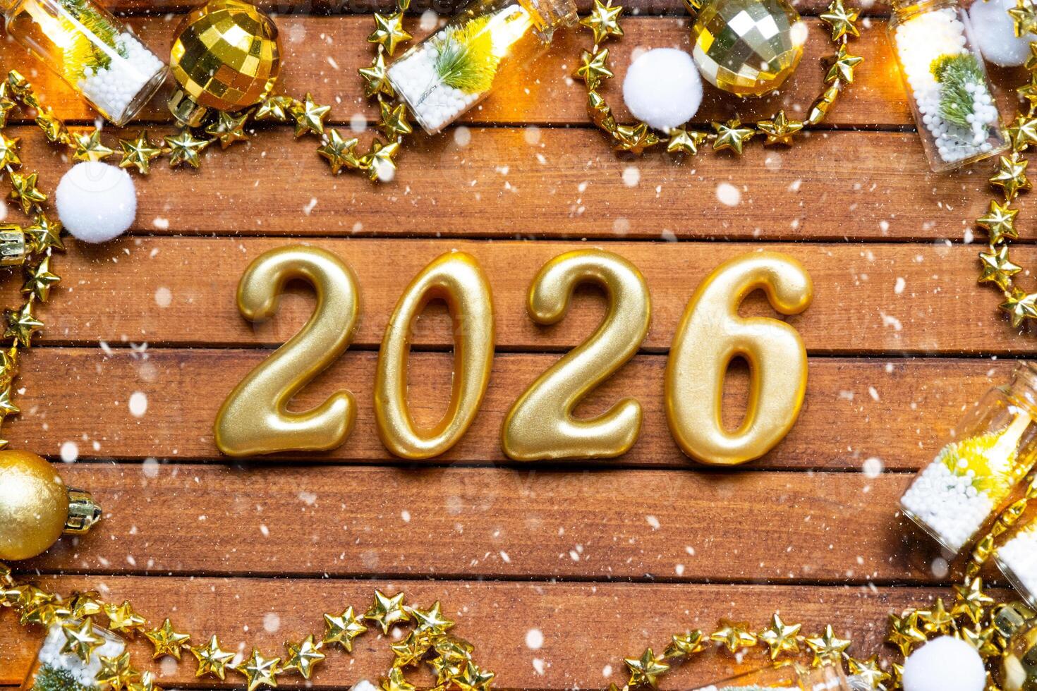 Happy New Year wooden numbers 2026 brown wooden background with sequins, snow, lights of garlands. Greetings, postcard. Calendar, cover photo