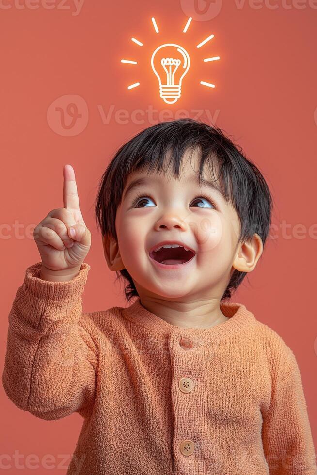 A child is smiling and pointing up at an idea light bulb photo