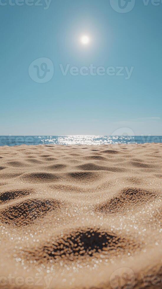 Sunny day at beach with soft sand and ocean view, bright sky. photo