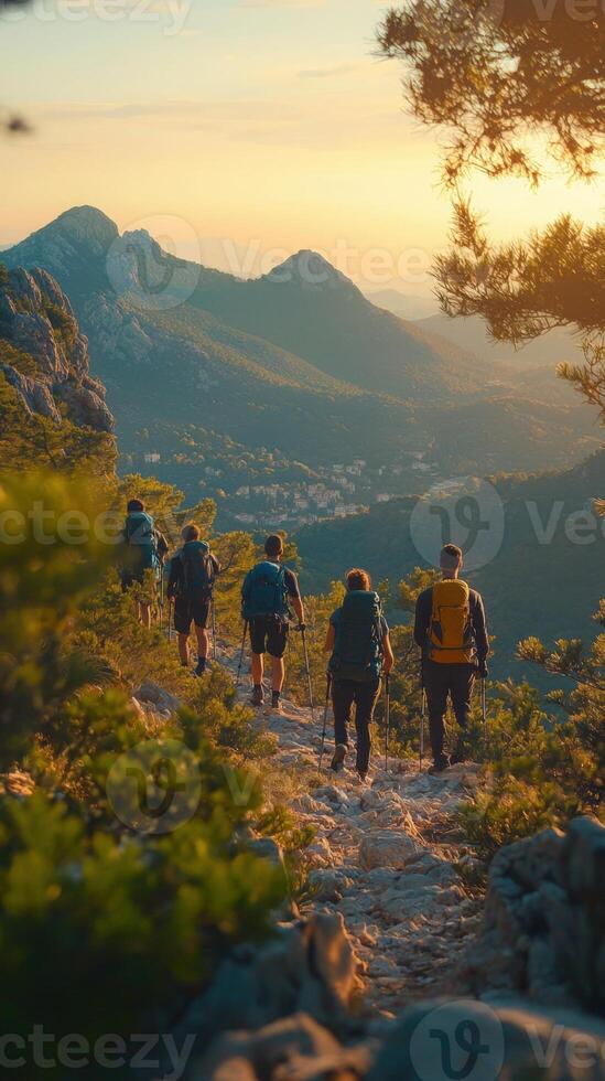 Hikers on trail at sunset with stunning mountain views, adventure and exploration, photo