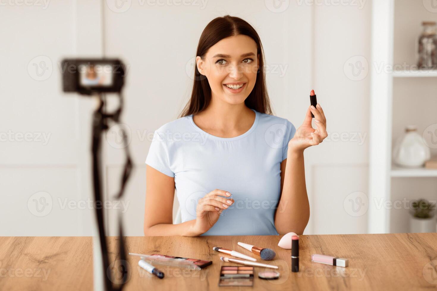 Beauty Blogging. Woman Making Makeup In Front Of Camera Creating Tutorial Sitting At Home. Selective Focus photo