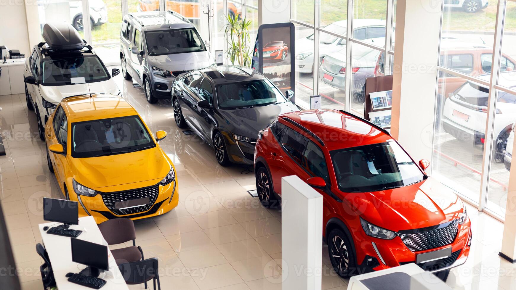 Top view of various beautiful modern sports, family, medium, multi purpose cars different colours and features at huge luxury dealership salon. Automobiles for sale, auto showroom, copy space photo