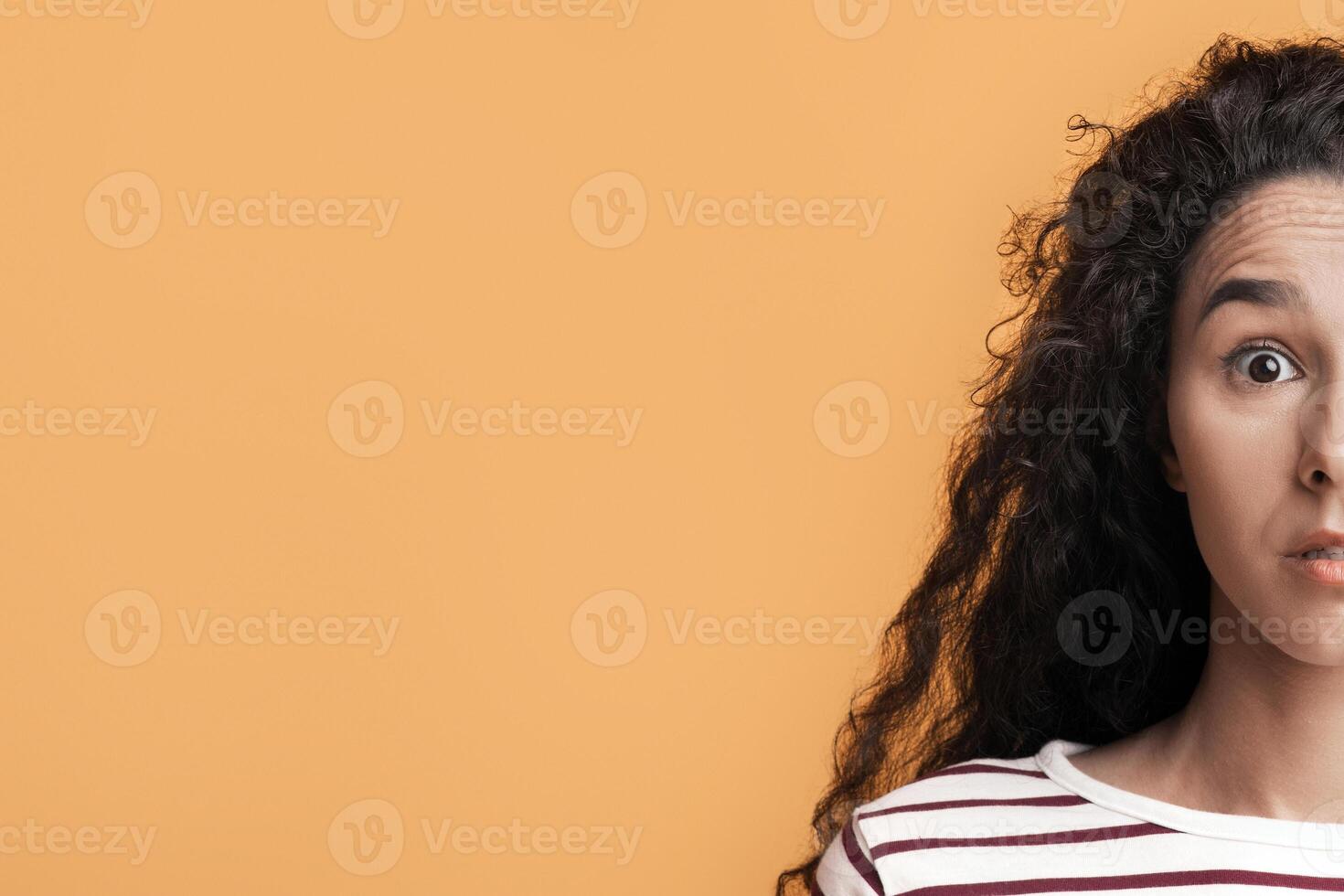 Human Emotions. Portrait Of Dazed Young Brunette Woman Looking At Camera With Shock, Closeup Shot Of Surprised Millennial Female Emotionally Reacting To News, Posing On Yellow Background, Free Space photo