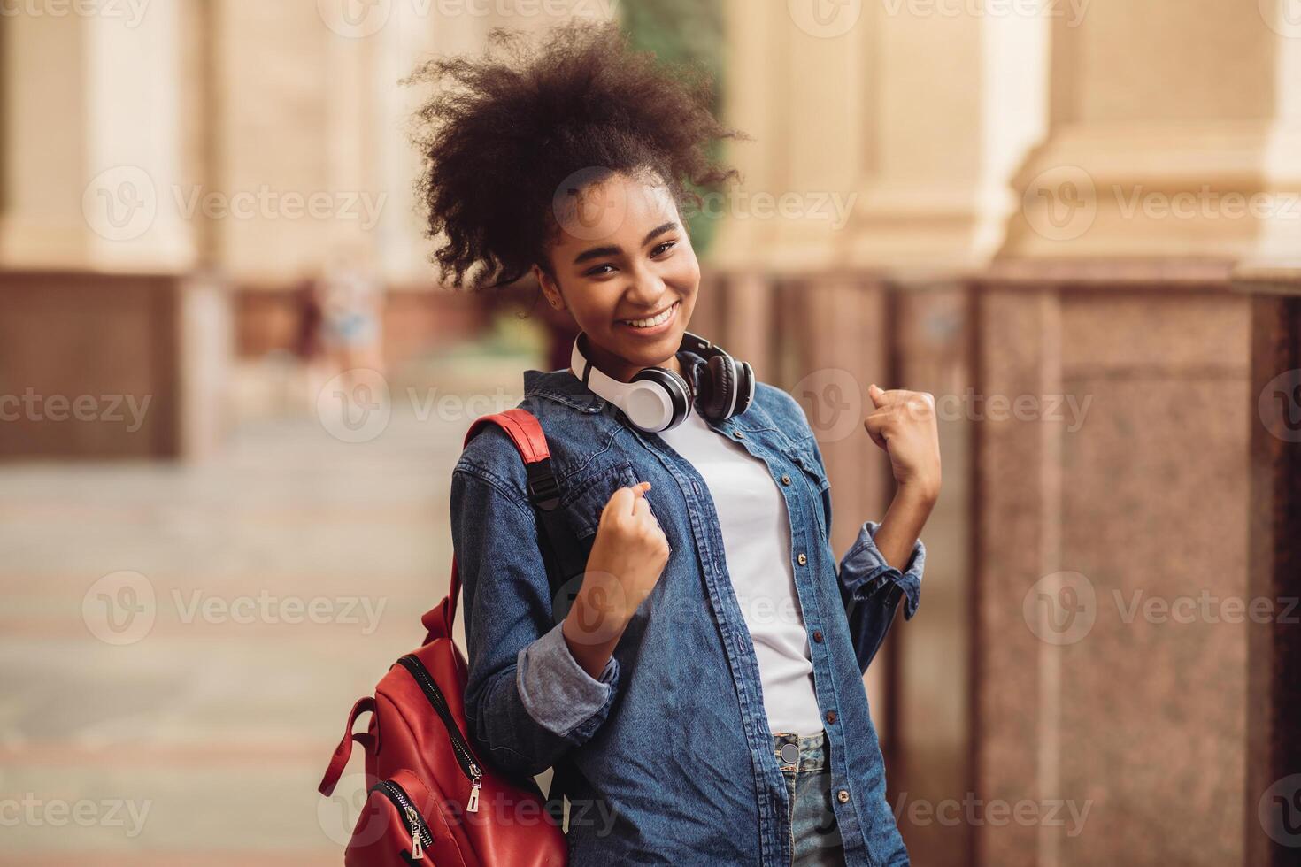 Cheerful African American Student Girl Celebrating Passed Exam Gesturing Yes Smiling To Camera Posing With Backpack Standing Outside Of College Building. I Did It, Educational Success Concept photo