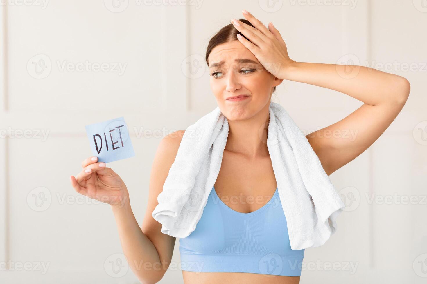 Dieting Choice. Puzzled Girl Holding Paper Card With Word Diet, Touching Head In Confusion Losing Weight At Home photo