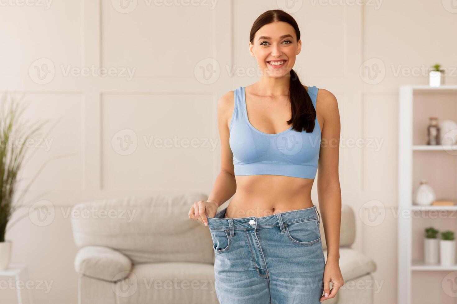 Weight Loss. Happy Girl Wearing Too Big Jeans After Slimming And Dieting At Home. Free Space For Text 55171023 Stock Photo at Vecteezy Weight Loss. Happy Girl Wearing Too Big Jeans After Slimming And Dieting At Home. Free Space For Text 55171023 Stock Photo at Vecteezy