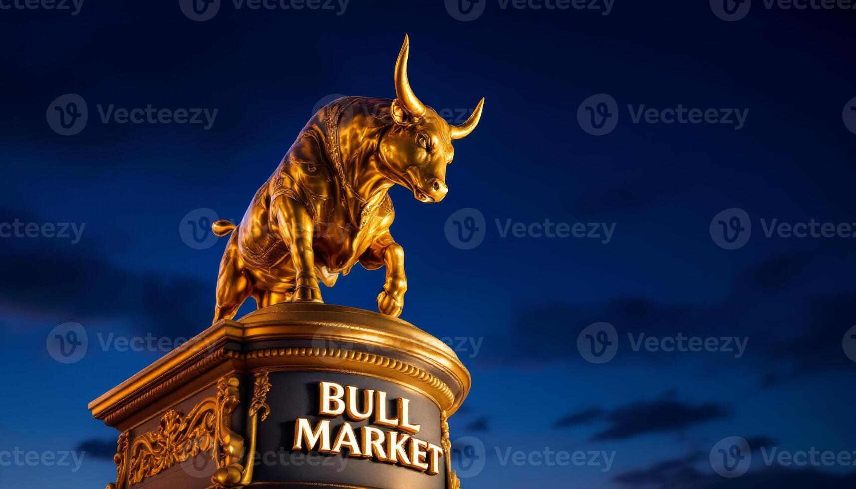 Golden Bull of the Market Stands Guard at Twilight against the Deep Blue Sky photo