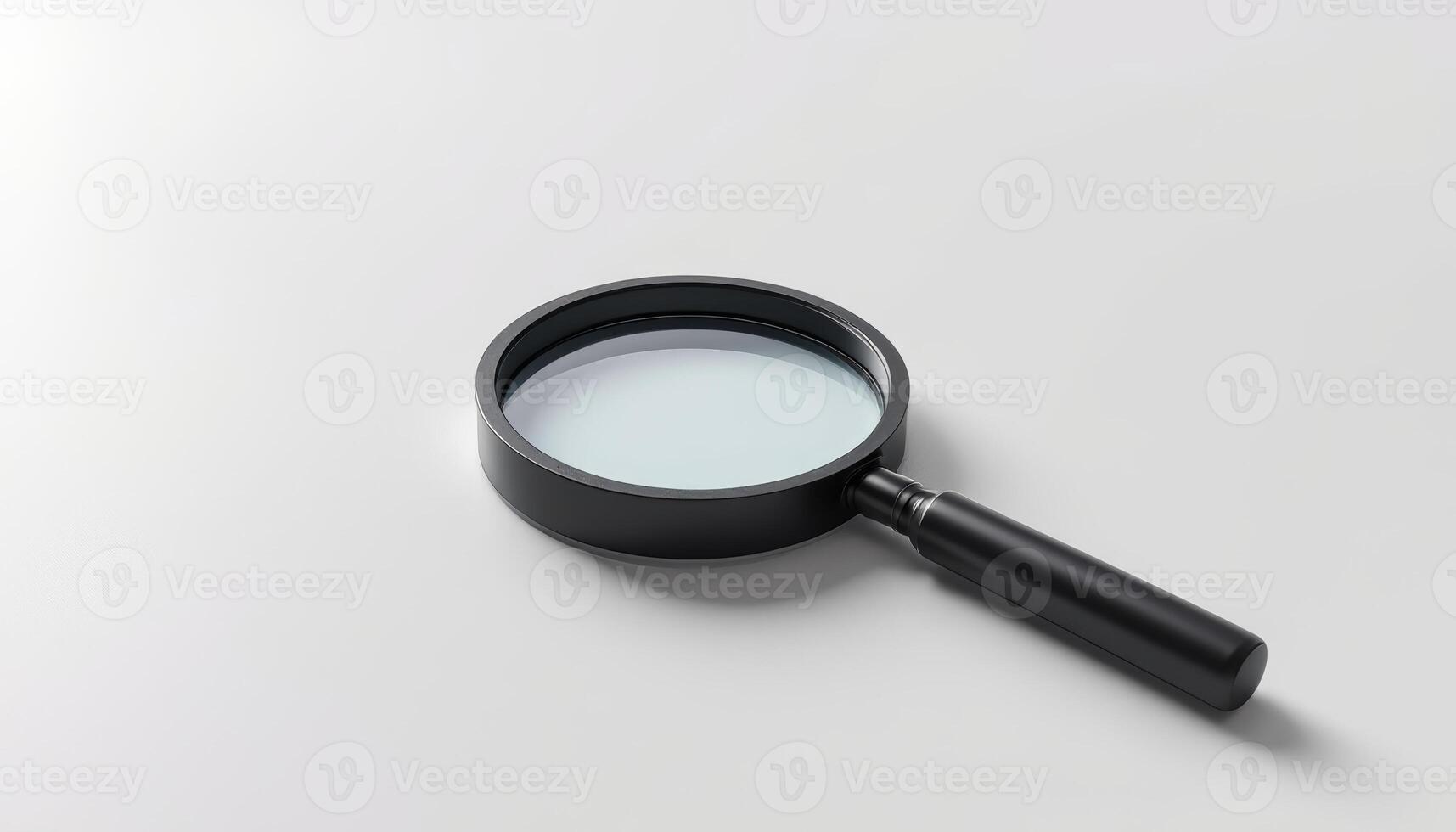 A Black Framed Magnifying Glass Tool Lying Flat on a White Surface for Study or Research photo