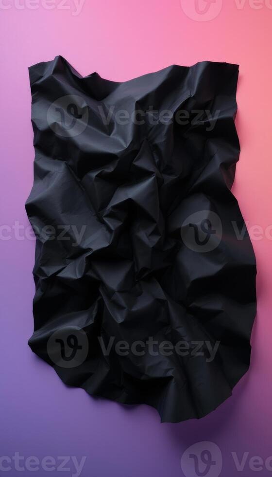 Crumpled black paper contrasts with a vibrant gradient background showing a rough texture photo