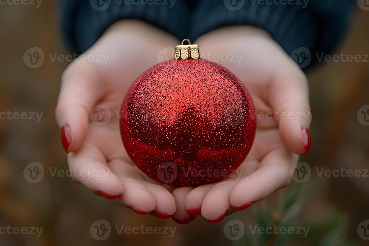 Festive Red Christmas Ornament Held in Hands - Holiday Decor and Warmth photo