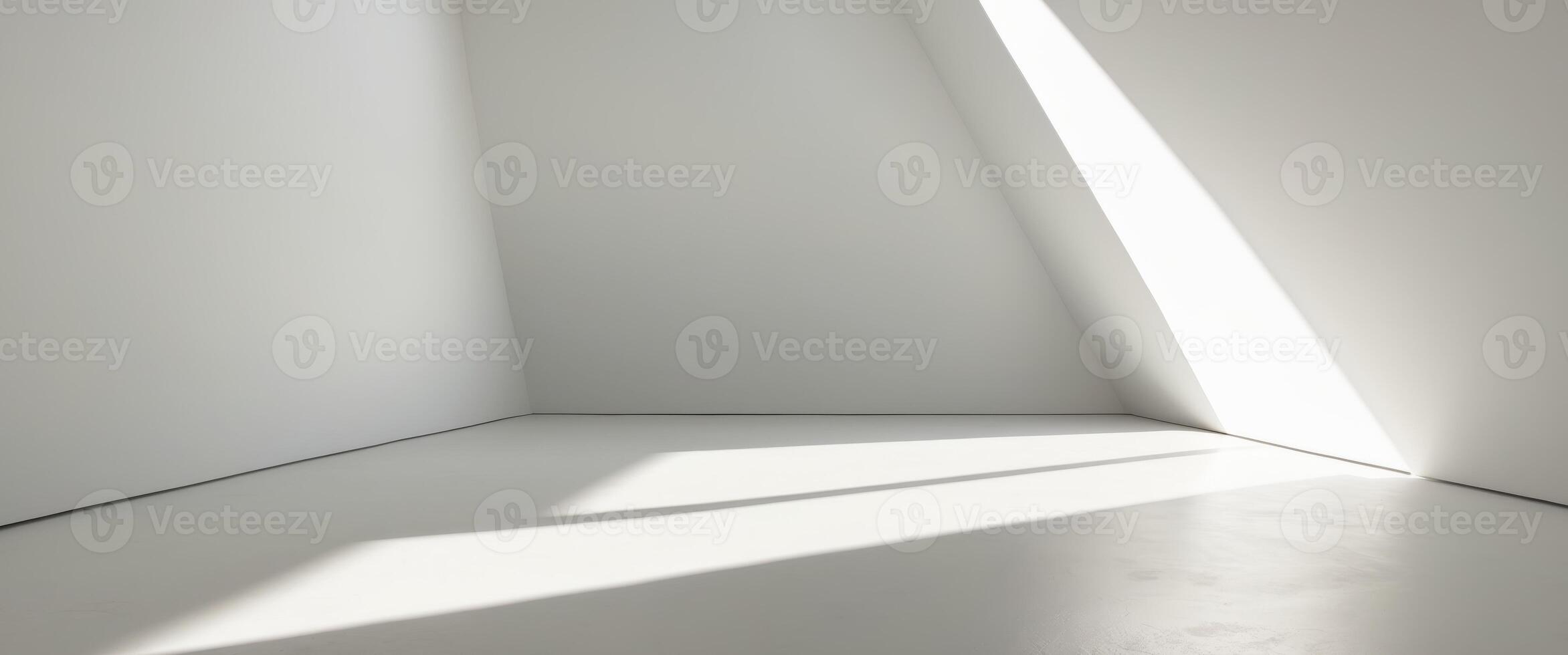 A bright white room with angled walls and a single light source casting a shadow. photo