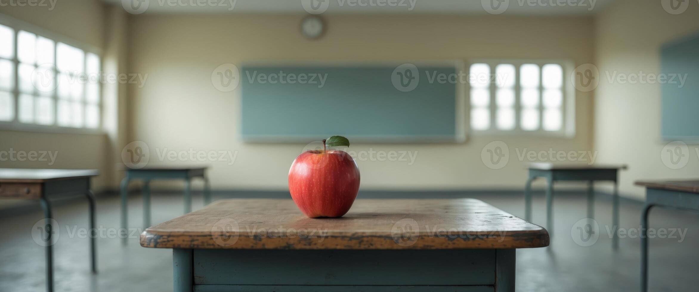 Red Apple Sits On Desk In Empty Classroom photo