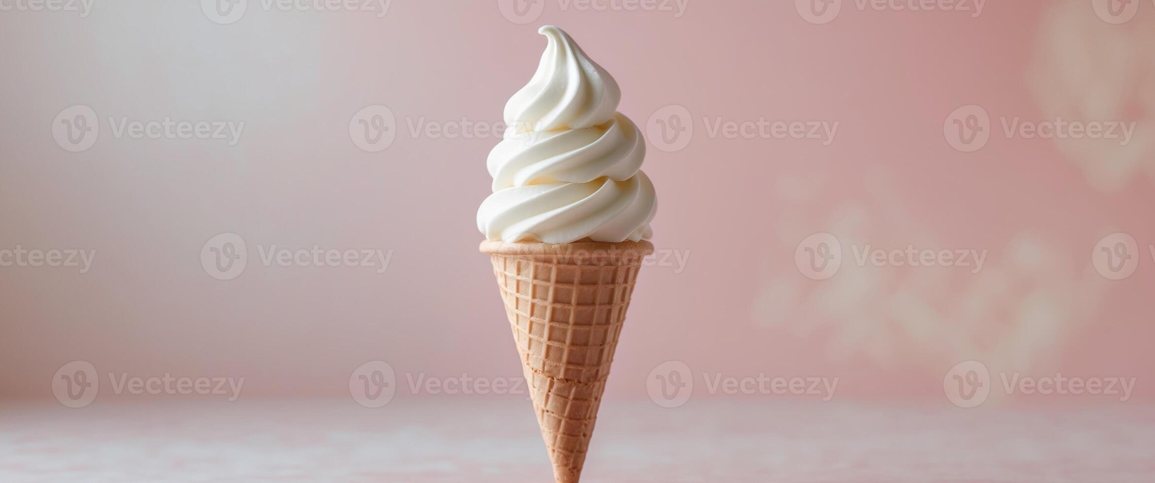 Vanilla Soft Serve Ice Cream Cone on soft pink background photo