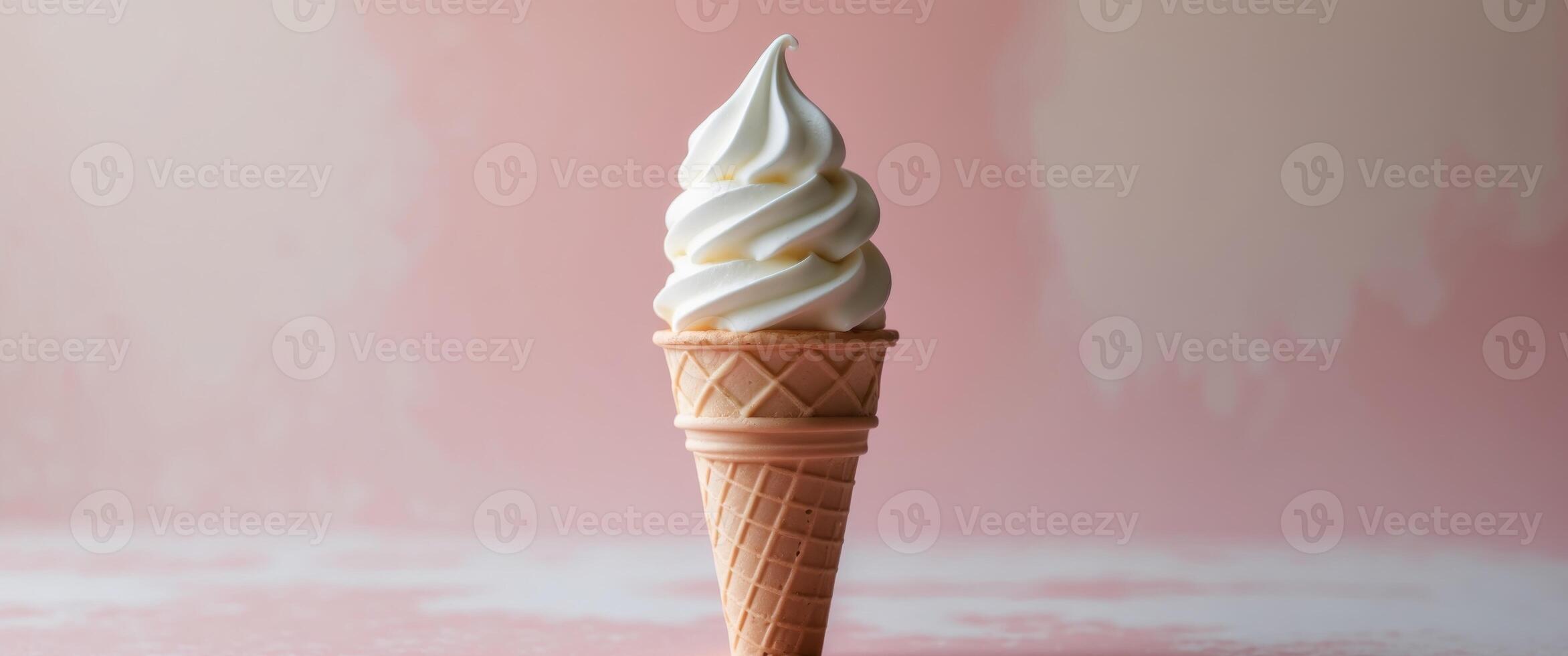 Vanilla Soft Serve Ice Cream Cone on soft pink background. photo