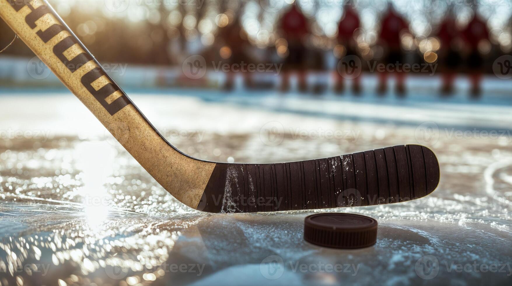 Hockey stick and puck on ice rink with players in background photo