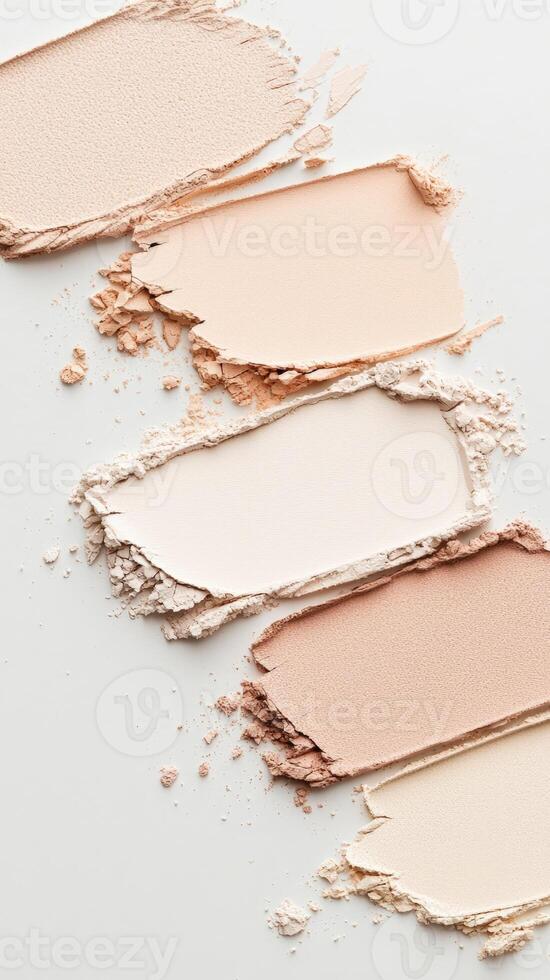 Foundation samples blending across white surface, displaying gradient makeup palette for cosmetic compact powder design photo