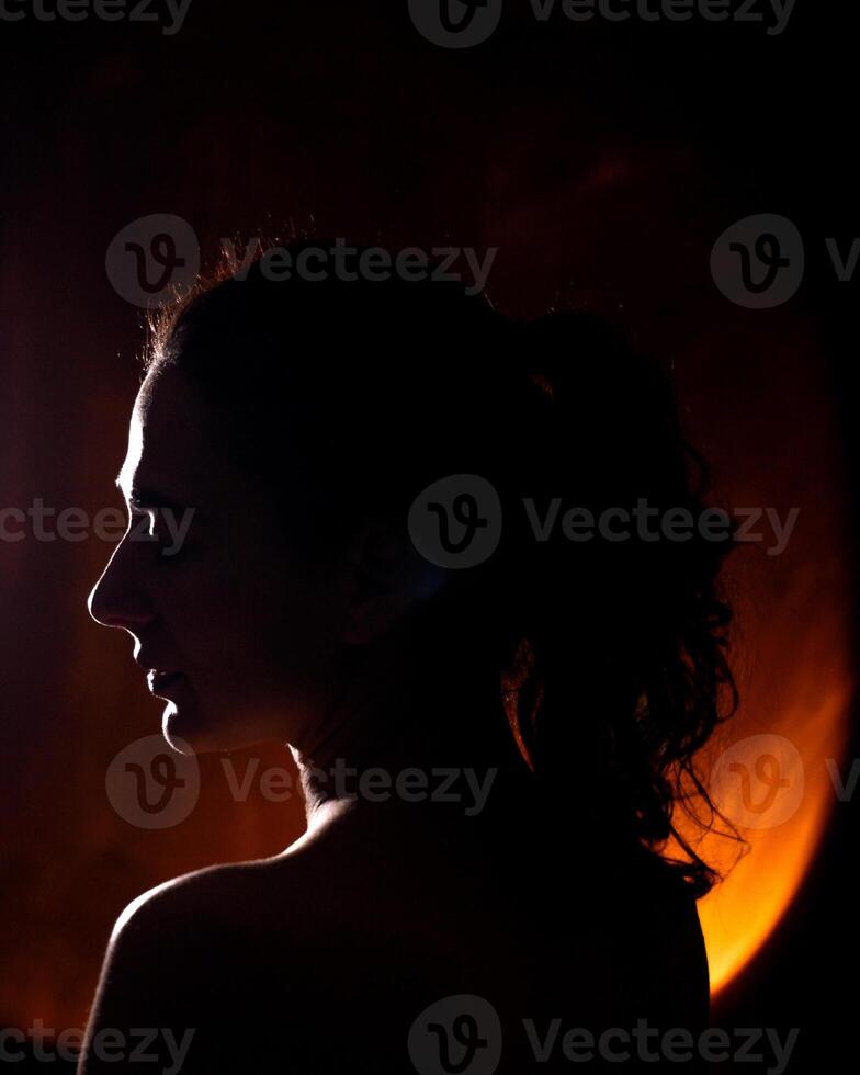 A woman's portrait in a silhouette with an artificial light photo