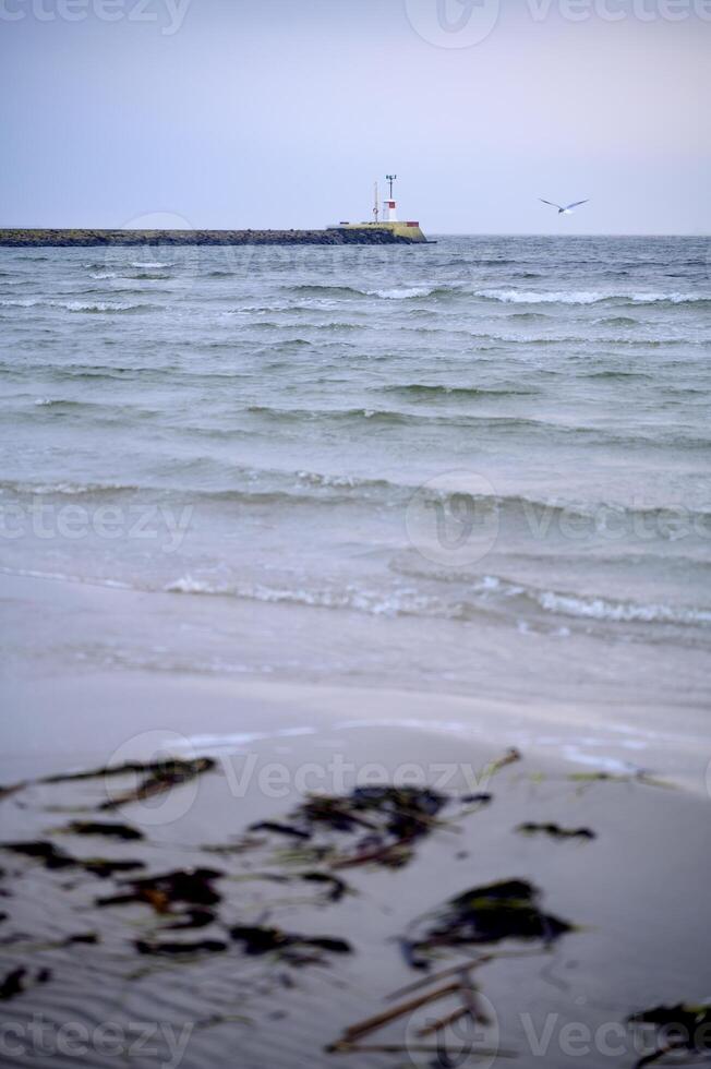 A lighthouse far away in the sea Lomma beach Sweden 2025 photo