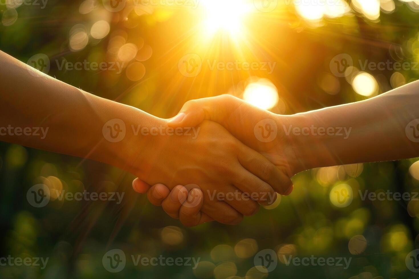 Two hands embrace warmly under a golden sunset, symbolizing unity, trust, and connection photo