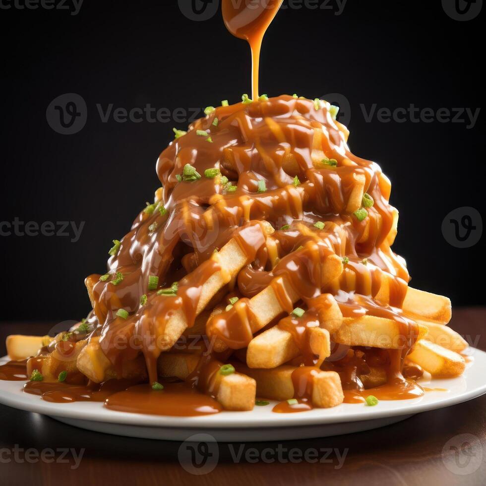 A plate of poutine, a Canadian dish consisting of French fries topped with cheese curds and gravy. photo