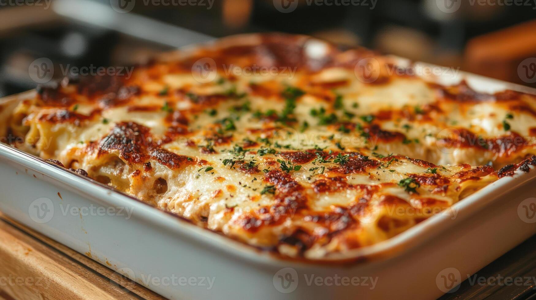 A close-up photograph of a baked pasta dish with melted cheese and herbs on top photo