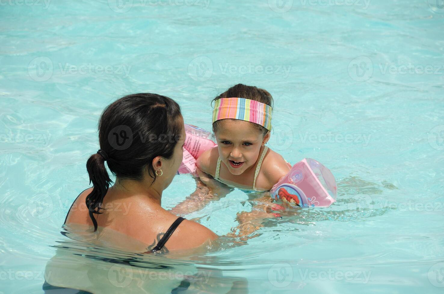 Child is learning to swim photo