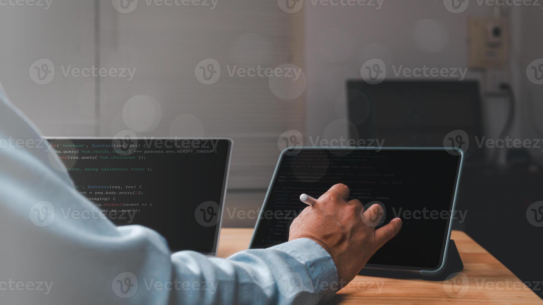 Developer interacts with code on tablet, dynamic workspace rich in technology and creativity scene highlights integration of programming and modern tools photo