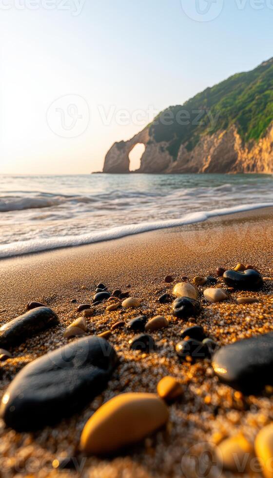A beach with a rocky shoreline and a mountain in the background photo