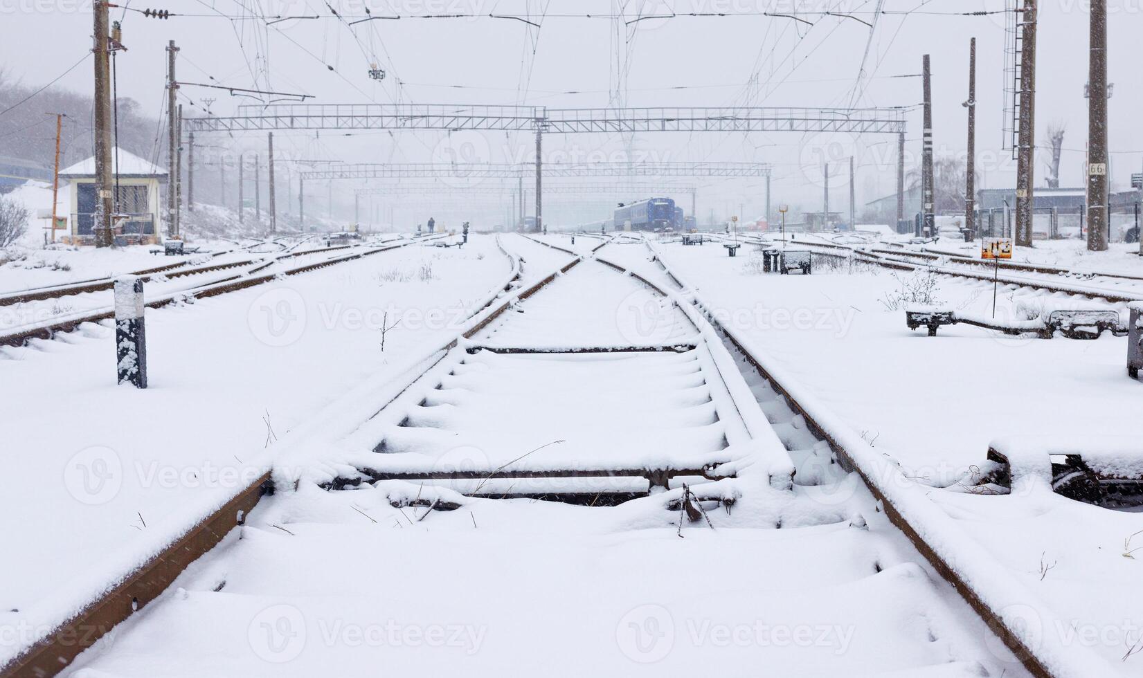 Snowfall covers a railway station with many tracks with fluffy snow. photo