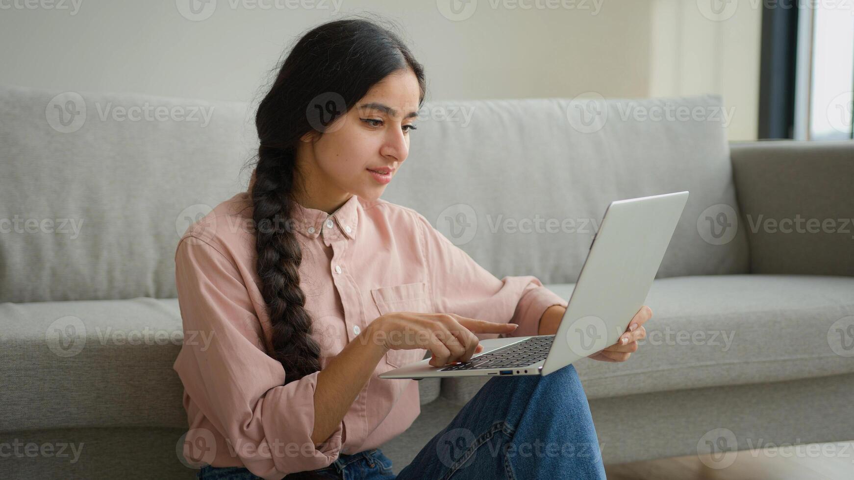 Relaxed Arabian woman student sit on floor at home working with computer remote education e-learning write business project online Indian businesswoman girl make internet order search computer website photo