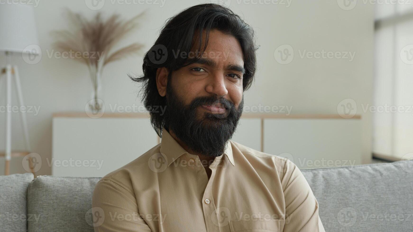 Portrait happy joyful Arabian muslim man guy Indian muslim businessman at home office male ethnic wise business entrepreneur house renter turn head to camera smiling bearded homeowner in living room photo