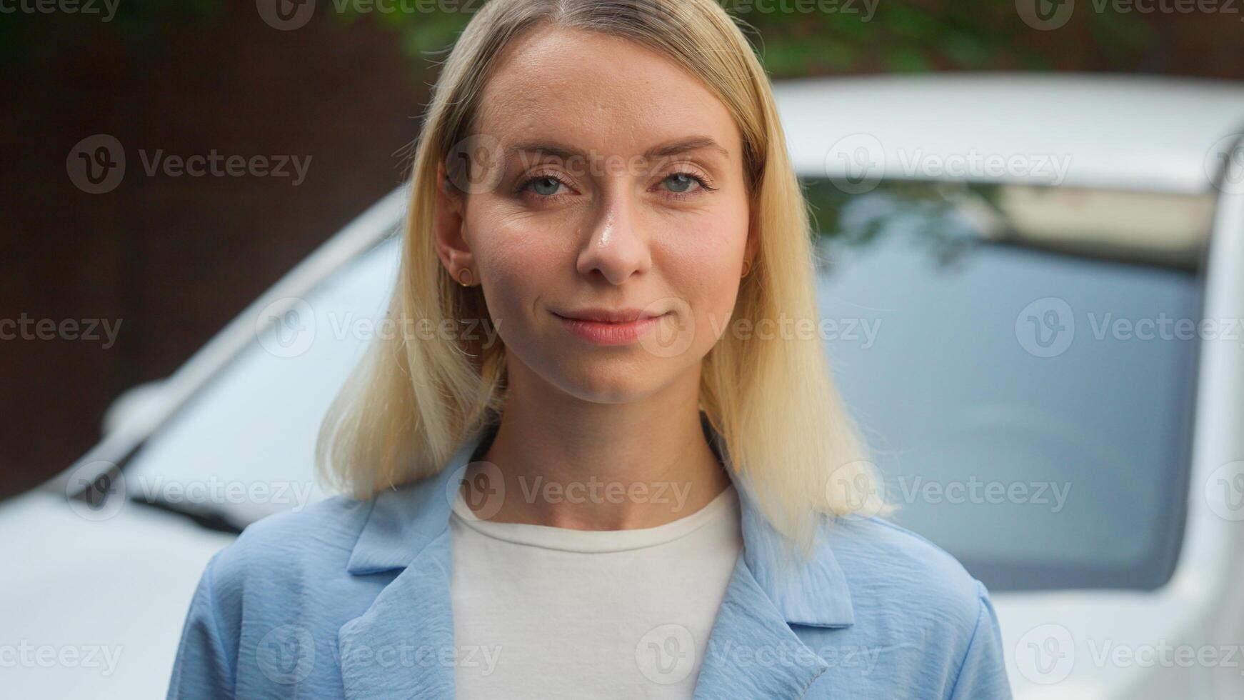 Positive glad Caucasian lady vehicle driver automobile transport buyer business woman portrait posing outdoors businesswoman smile female girl looking at camera in city finance ownership car auto rent photo