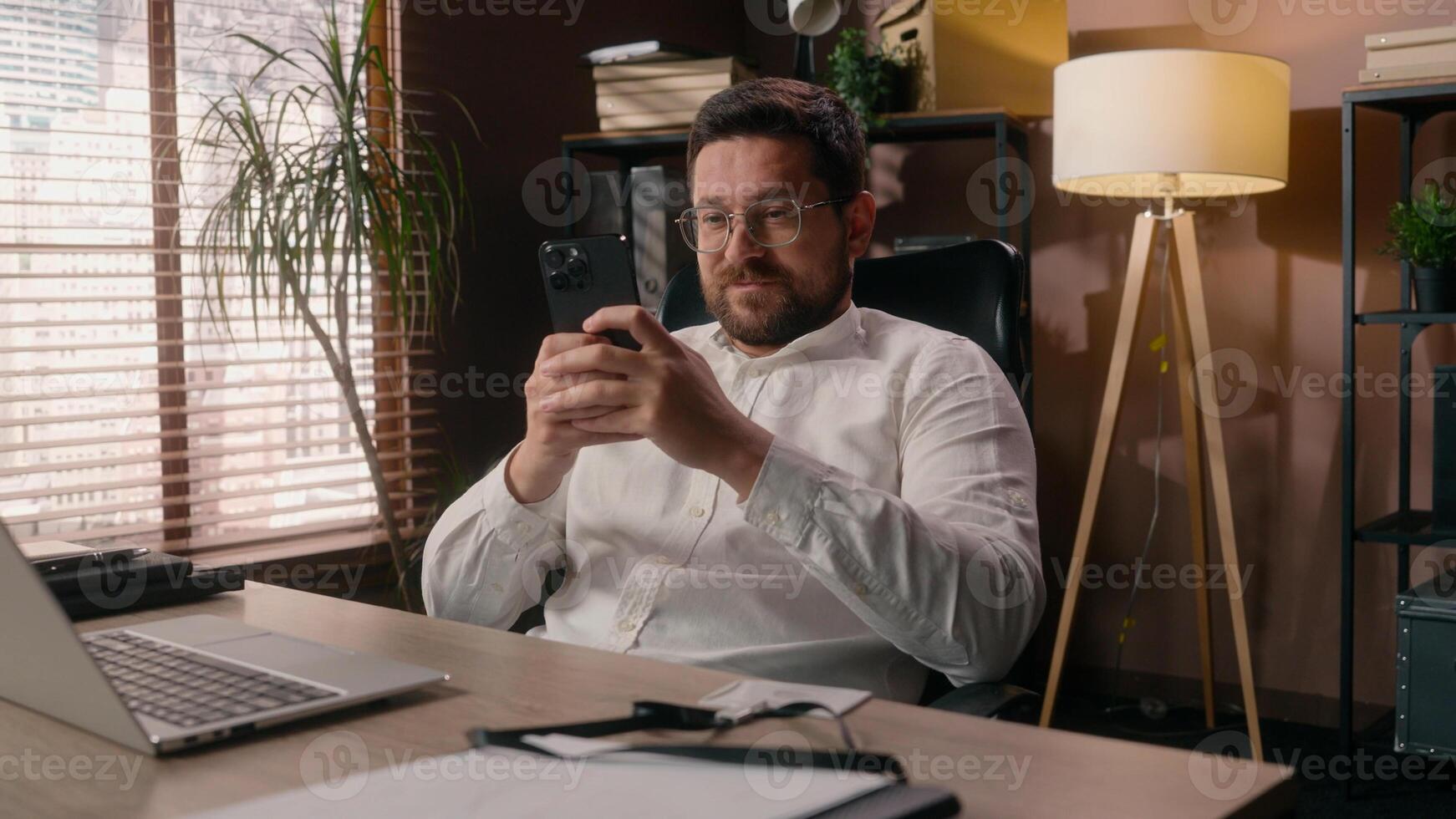 Caucasian business male relaxing entrepreneur leader using mobile phone in office guy businessman boss agent ceo typing smartphone cyberspace addict man lazy executive chat online in social media tech photo