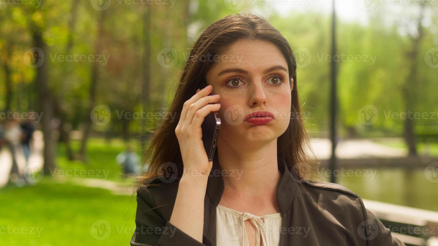 Caucasian woman talking mobile phone smartphone tension dissatisfied boss businesswoman quarrel shouting angry female screaming call negative annoyed device work problem client park city girl arguing photo