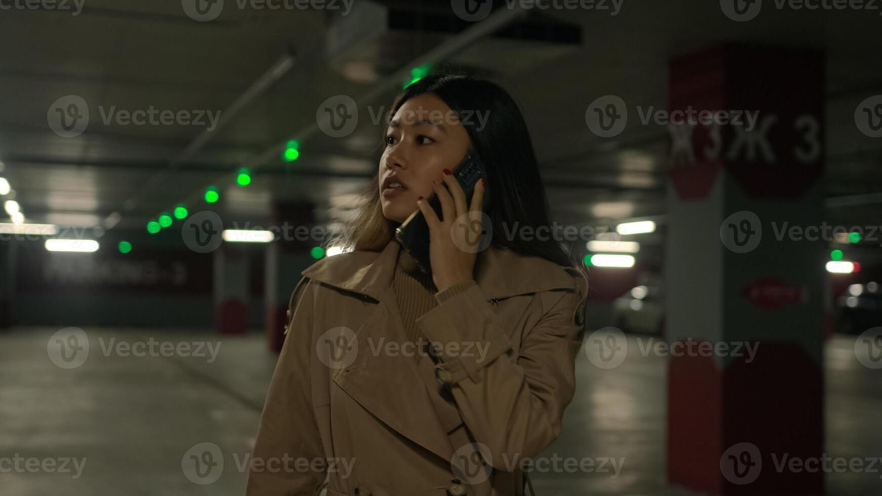 Annoyed Asian irritated woman chinese multiethnic businesswoman girl lady solve conflict problem talk mobile phone walking in car parking search auto taxi in underground business call quarrel arguing photo