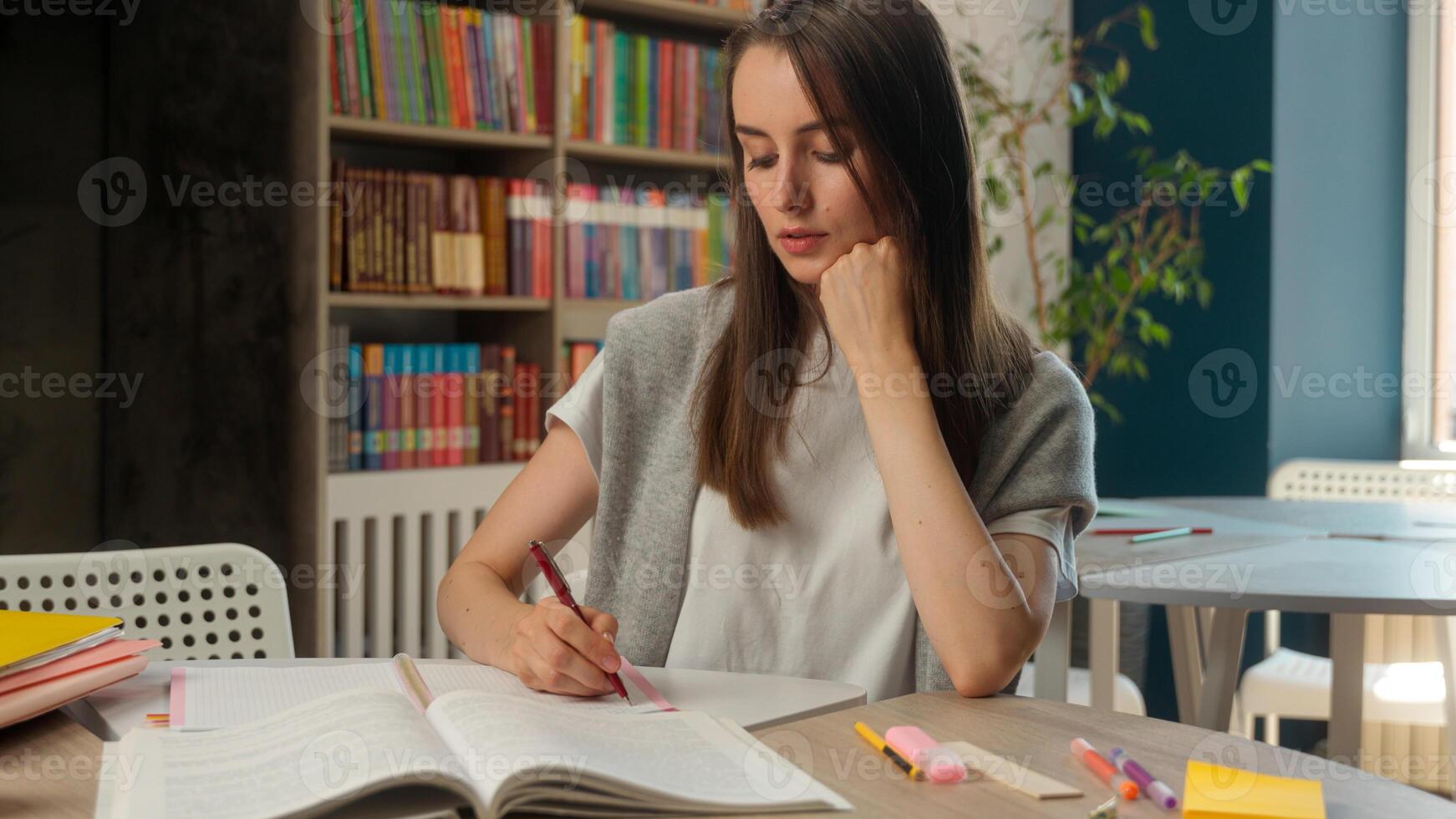 Caucasian woman businesswoman classroom library teacher student girl study learning writing notebook notes exam preparation female business indoor education university high school lesson write course photo