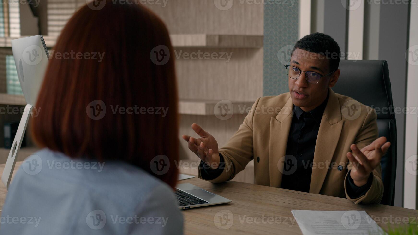 African American man businessman HR manager trader estate agent salesman consulting woman customer job interview recruitment consultation with client two business partners talk at office negotiation photo