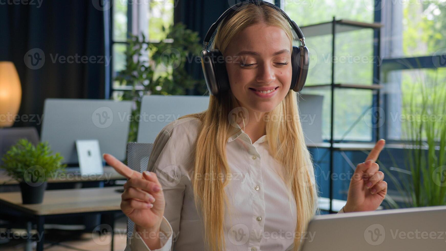 Caucasian woman girl take work break at office relaxed businesswoman smile listen music in headphones on laptop online musical service business manager listening in earphones enjoy melody dancing move photo